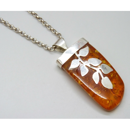 7117 - A large silver and amber pendant and chain, and an amber and ruby bracelet