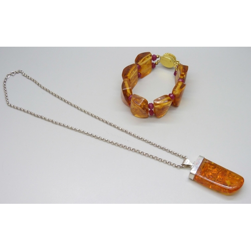 7117 - A large silver and amber pendant and chain, and an amber and ruby bracelet