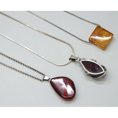 7135 - Three silver and amber pendants and chains, 32g