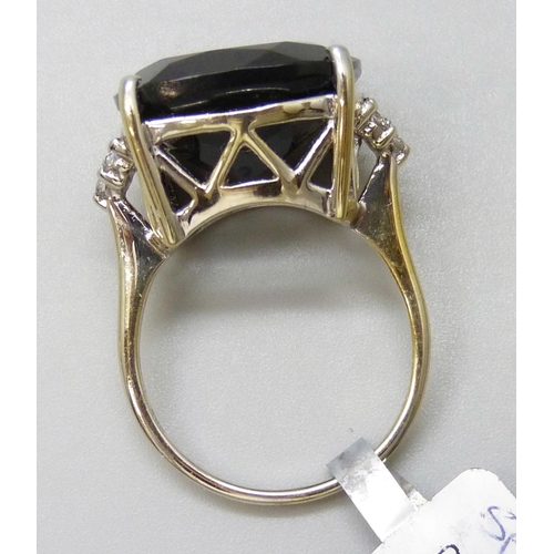 7139 - A silver ring set with a large black stone and white stone shoulders, U