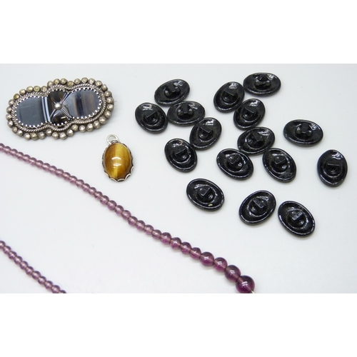 7143 - A French jet necklet, two sets of jet style buttons, a tiger's eye pendant, purple bead necklet and ... 