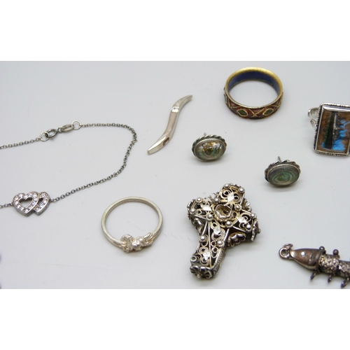 7146 - A collection of jewellery including two pairs of silver earrings, a silver pendant, and a silver bra... 