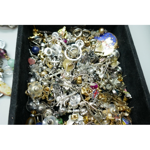 7167 - A box of costume jewellery, a tray of earrings and badges