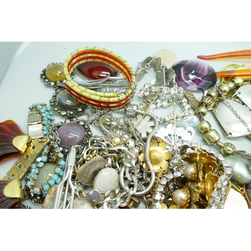 7167 - A box of costume jewellery, a tray of earrings and badges