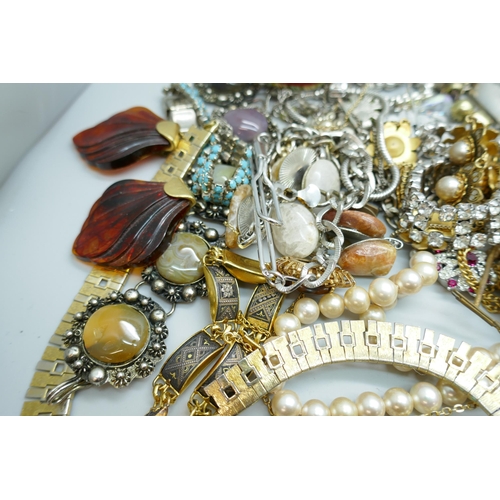 7167 - A box of costume jewellery, a tray of earrings and badges