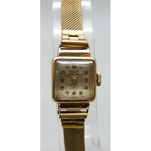 7181 - An 18ct gold cased lady's wristwatch on a plated strap, 17mm including crown