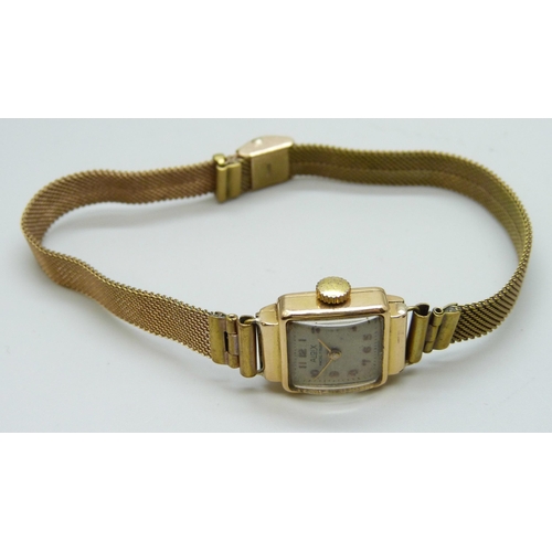 7181 - An 18ct gold cased lady's wristwatch on a plated strap, 17mm including crown