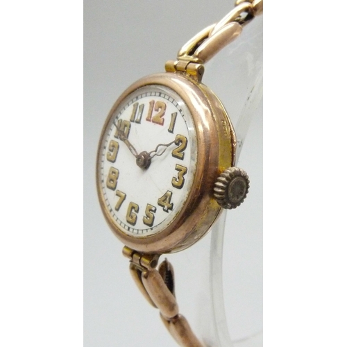 7188 - A 9ct gold cased wristwatch on a 9ct gold strap, 28mm including crown, 21g total weight