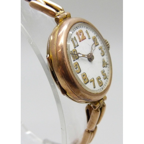 7188 - A 9ct gold cased wristwatch on a 9ct gold strap, 28mm including crown, 21g total weight