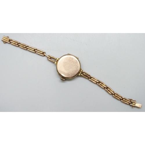 7188 - A 9ct gold cased wristwatch on a 9ct gold strap, 28mm including crown, 21g total weight