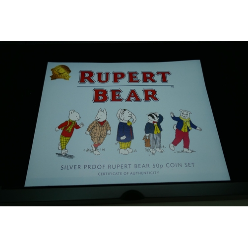 7233 - Coins; an Isle of Man 2020 issue of five 925 silver Rupert Bear collectors 50p proof coin set, cased... 