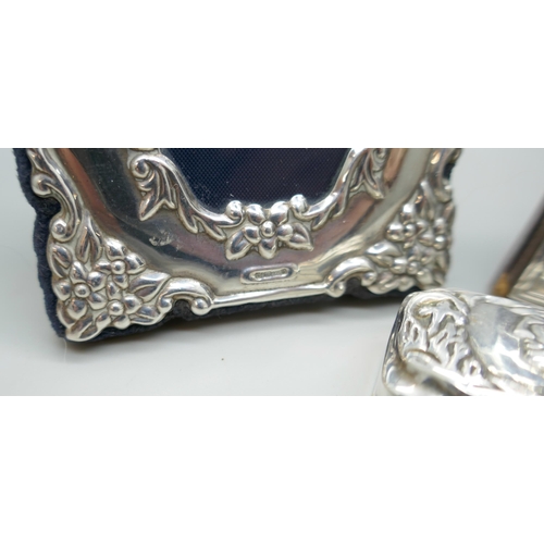 7244 - Two small silver photograph frames, tallest 10.7cm, and a silver pill box