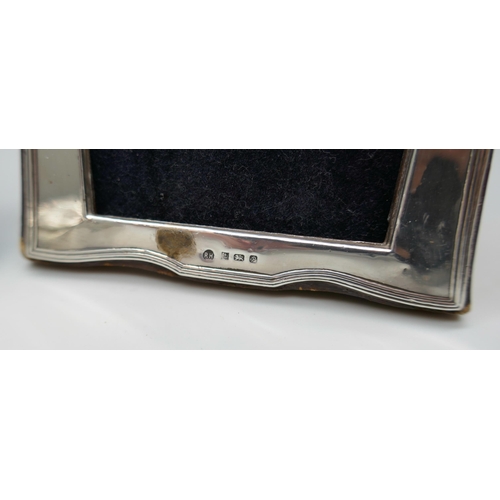 7244 - Two small silver photograph frames, tallest 10.7cm, and a silver pill box