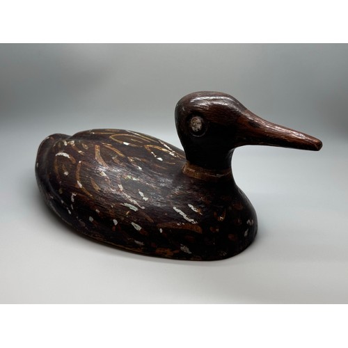 2028 - An early 20th Century decoy model of a duck, hand carved and painted, signed, 29cm long