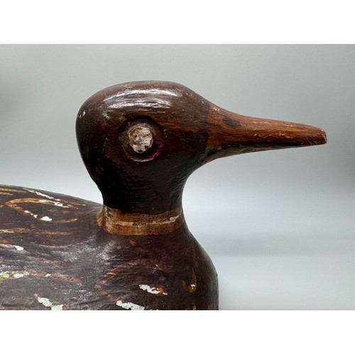 2028 - An early 20th Century decoy model of a duck, hand carved and painted, signed, 29cm long