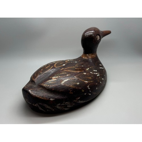 2028 - An early 20th Century decoy model of a duck, hand carved and painted, signed, 29cm long