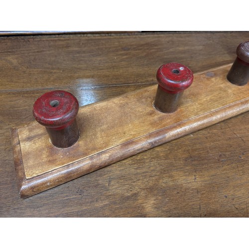 2179 - A set of beech mounted hand painted coat hooks, 77cm