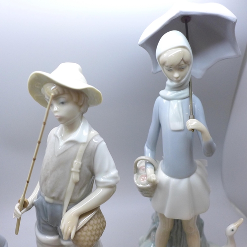 2001 - Four Lladro figures, including Young Fisherman, H-16 E, Girl with ducks and umbrella, another girl w... 