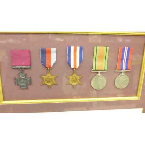 2005 - A group of four mounted World War II medals with a replica Victoria Cross, with commemorative inscri... 