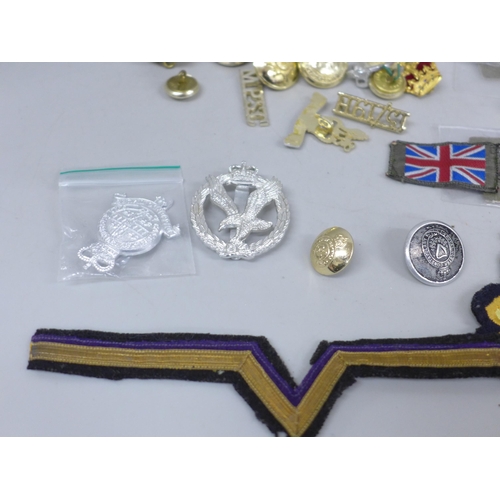 2020 - A collection of military uniform patches, cap badges and buttons