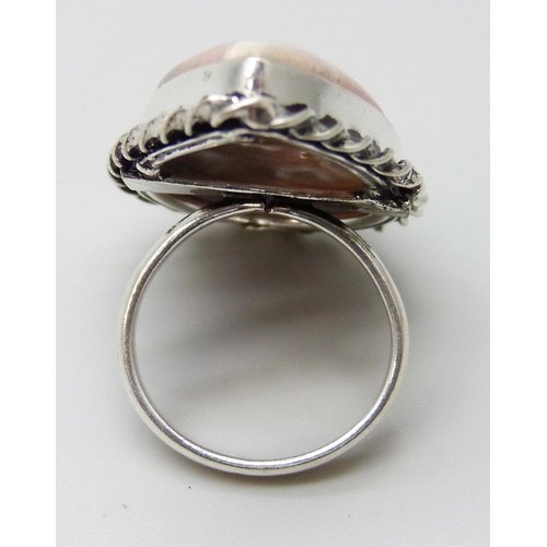 2026 - A silver plated ring with twist design border, set with a pear shape cabochon rhodonite stone, size ... 