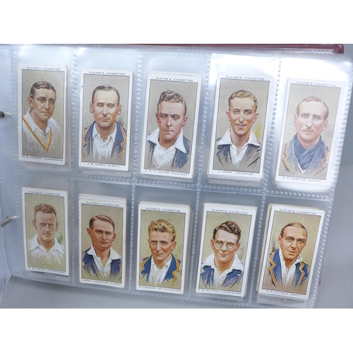 2037 - Cigarette cards; an album of nine sets of cigarette cards including Player's 'Cricketers-1930, 1934 ... 