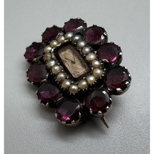 2039 - A William IV yellow metal set garnet and seed pearl mourning brooch with hair panel, inscription ver... 