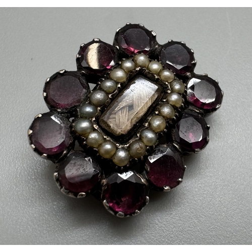 2039 - A William IV yellow metal set garnet and seed pearl mourning brooch with hair panel, inscription ver... 