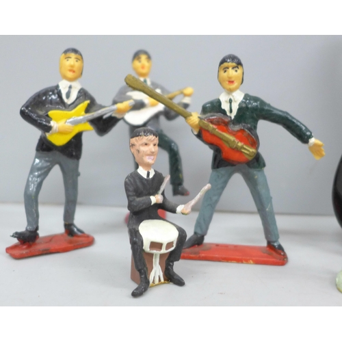 2076 - The Beatles; a collection of figures and a guitar