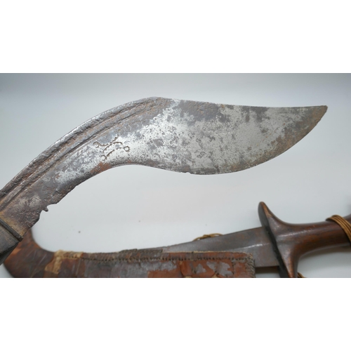 2209 - A Kukri and Persian knife, scabbard split and handle a/f, *This lot is not available for packing and... 