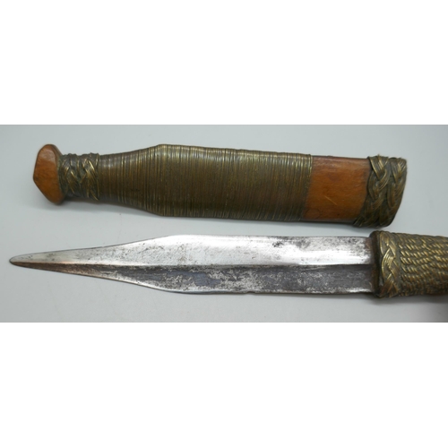 2211 - An African tribal dagger with scabbard, 20.5cm *This lot is not available for packing and posting*