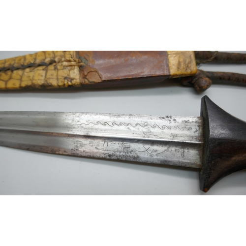 2213 - An African armlet dagger, handle chipped *This lot is not available for packing and posting