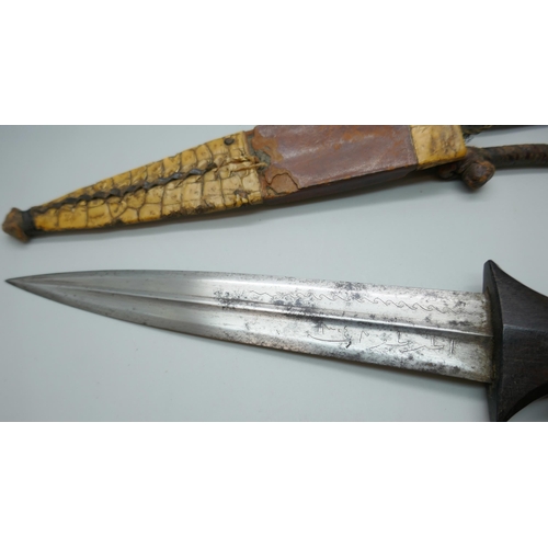 2213 - An African armlet dagger, handle chipped *This lot is not available for packing and posting