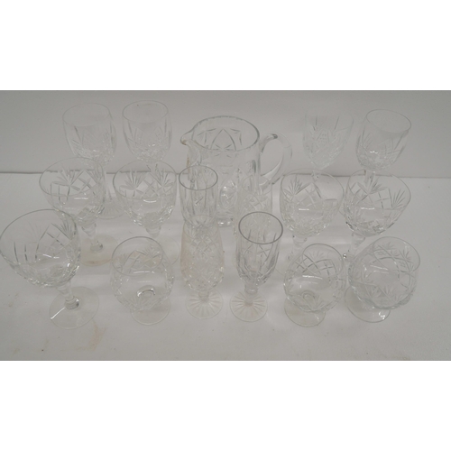 2303 - A collection of cut glass crystal to include water jug, wine glasses, brandy glasses, etc. **PLEASE ... 