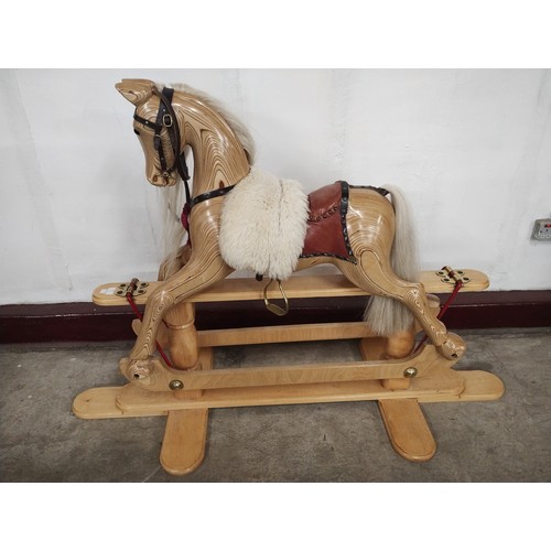 258 - A Victorian style child's carved beech rocking horse