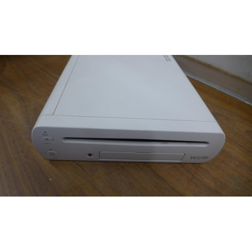 5090C - A quantity of gaming related electronics including a Wii U console with nun-chuck remote attachment,... 