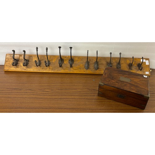 334 - A Victorian walnut and brass writing slope and a coat rack