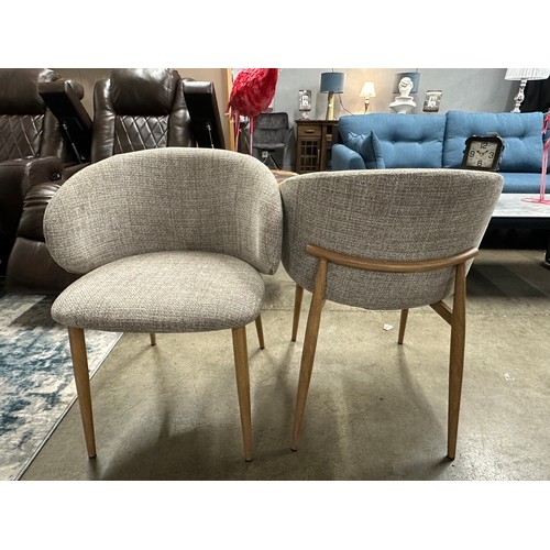 3043 - A pair of beige upholstered curved dining chairs *This lot is subject to VAT