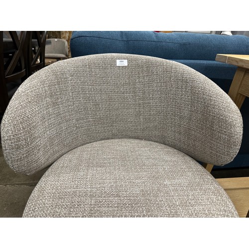 3084 - A beige upholstered curved back dining chair *This lot is subject to VAT