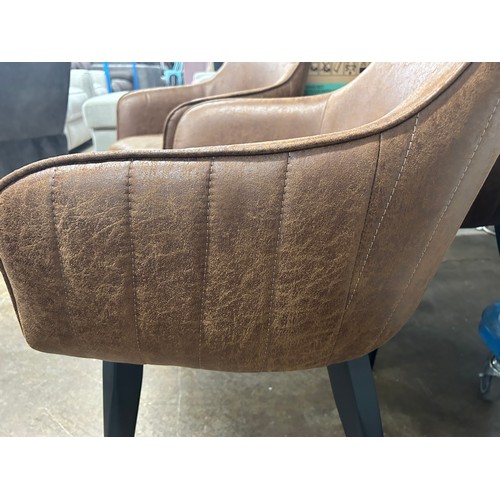 3180 - A set of three brown faux leather dining chairs *This lot is subject to VAT