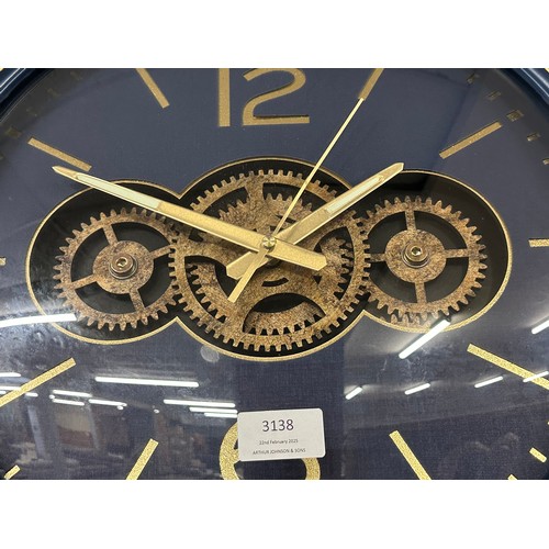 3138 - A navy and gold moving gear clock (clock hands require attention)