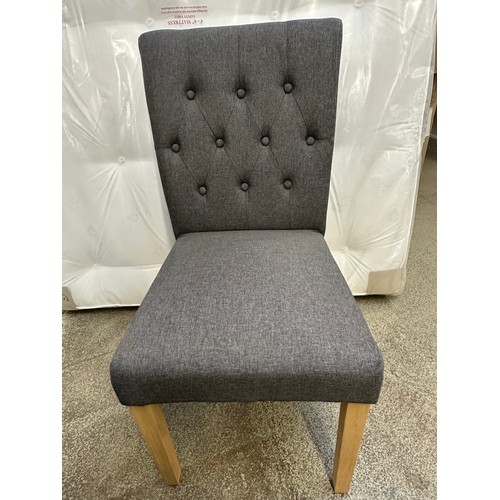 3285 - A pair of grey buttoned dining chairs with wooden legs *This lot is subject to VAT