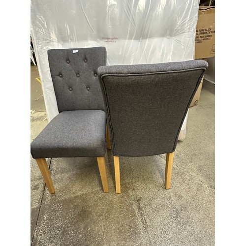 3285 - A pair of grey buttoned dining chairs with wooden legs *This lot is subject to VAT