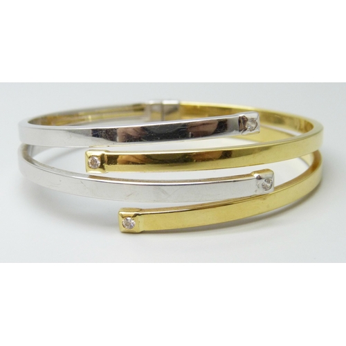 7247 - An Italian 18ct gold bangle, white/yellow gold set with white stones, spring hinge opening, 5.6 x 4.... 