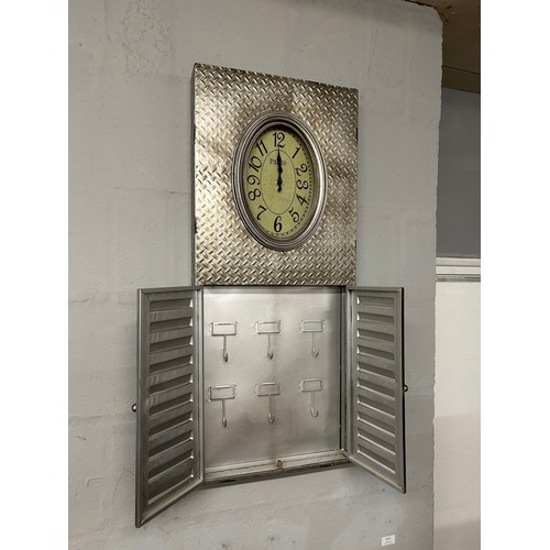 3036 - A metal wall clock with a key cupboard