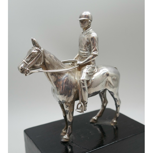 7315 - A Mappin & Webb Ltd. silver model of a horse and jockey, London 1913, model 9cm, 14cm including base... 