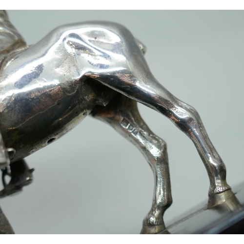 7315 - A Mappin & Webb Ltd. silver model of a horse and jockey, London 1913, model 9cm, 14cm including base... 