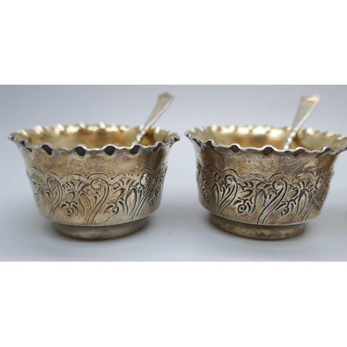 7323 - A pair of Victorian silver salts with matching spoons, and three silver napkin rings, 125g