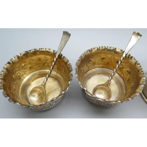 7323 - A pair of Victorian silver salts with matching spoons, and three silver napkin rings, 125g