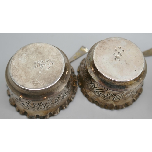 7323 - A pair of Victorian silver salts with matching spoons, and three silver napkin rings, 125g